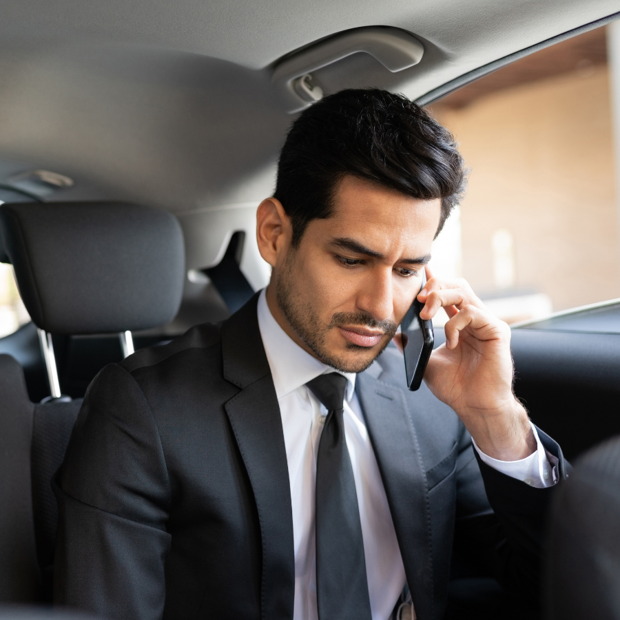 Man talking on cell phone in car