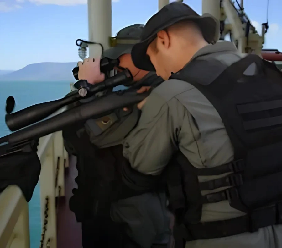 Two private maritime security officers protecting a ship from pirates